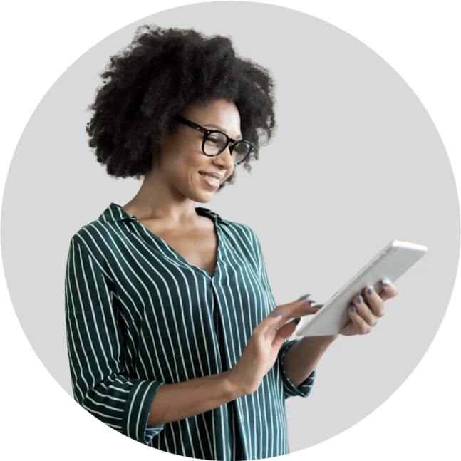 A lady smiles while holding a tablet computer.