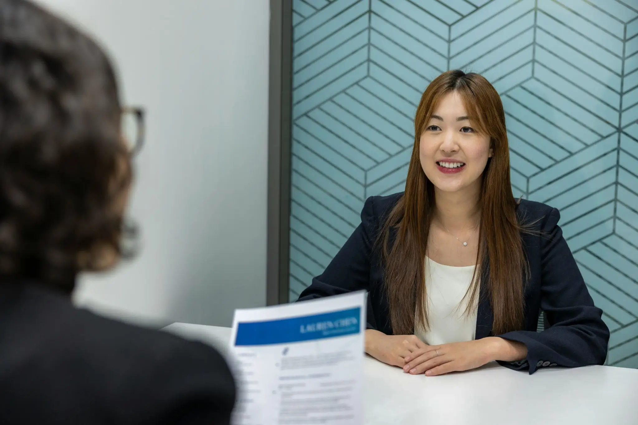 Candidate participating in a face-to-face job interview across a meeting table